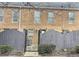 Exterior view of brick building with gate and partially fenced backyard at 235 Winding River Dr # B, Atlanta, GA 30350