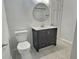 Bathroom featuring a modern vanity with storage, a circular mirror, and bright tile flooring at 235 Winding River Dr # B, Atlanta, GA 30350