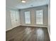 Bedroom with modern flooring, neutral walls, double door closet, and bright windows with blinds at 235 Winding River Dr # B, Atlanta, GA 30350