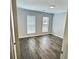 Bedroom with gray toned walls and modern flooring, featuring windows with blinds and ample light at 235 Winding River Dr # B, Atlanta, GA 30350