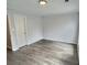 Spacious bedroom with neutral walls and flooring, ample natural light, and a modern door at 235 Winding River Dr # B, Atlanta, GA 30350