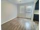 Cozy dining area featuring wood-look flooring, a bright window, and a convenient door to the outside at 235 Winding River Dr # B, Atlanta, GA 30350