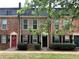 Brick townhomes with various colorful doors and well-kept landscaping at 235 Winding River Dr # B, Atlanta, GA 30350