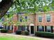 Traditional brick townhome with a red front door and manicured lawn at 235 Winding River Dr # B, Atlanta, GA 30350