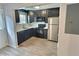 Modern kitchen featuring sleek appliances and dark wood cabinetry at 235 Winding River Dr # B, Atlanta, GA 30350