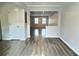 Open living room showcases wood floors and a view into other living spaces at 235 Winding River Dr # B, Atlanta, GA 30350