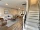 Inviting living room featuring wood floors, a staircase, and a modern aesthetic at 235 Winding River Dr # B, Atlanta, GA 30350