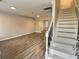 Bright living room with wood floors and staircase with white risers at 235 Winding River Dr # B, Atlanta, GA 30350