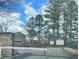 Community entrance gate with stone accents surrounded by mature trees at 235 Winding River Dr # B, Sandy Springs, GA 30350