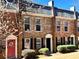 Charming brick townhouse with red door and manicured bushes in a well maintained community at 235 Winding River Dr # B, Sandy Springs, GA 30350