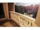 Elegant balcony with a white decorative railing, brick accents, and views of lush greenery at 2650 Riverfront Dr, Snellville, GA 30039