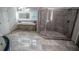 Bathroom featuring walk-in shower, dual sink vanity, and marble flooring at 2650 Riverfront Dr, Snellville, GA 30039