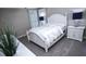 Cozy bedroom with neutral carpet, white furniture and plantation shutters at 2650 Riverfront Dr, Snellville, GA 30039