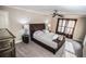 Bedroom with neutral walls, ceiling fan, a large bed, and decor at 2650 Riverfront Dr, Snellville, GA 30039