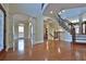 Grand foyer with hardwood floors, soaring ceilings, decorative columns, and a wrought iron staircase, offering a luxurious entrance at 2650 Riverfront Dr, Snellville, GA 30039