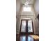 Grand foyer featuring stained glass front door and soaring ceiling with modern chandelier at 2650 Riverfront Dr, Snellville, GA 30039