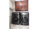 Modern laundry room features front-load washer and dryer units and storage cabinets at 2650 Riverfront Dr, Snellville, GA 30039