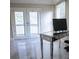Bright office area with french doors, stylish desk, and sleek marble floors at 2650 Riverfront Dr, Snellville, GA 30039