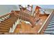 Elegant wooden staircase with wrought iron detailing connecting multiple levels of the home, showcasing craftsmanship at 2650 Riverfront Dr, Snellville, GA 30039