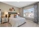 Inviting bedroom with a plush bed, bedside tables, lamps, and a window, creating a serene retreat at 523 Lanier Way, Temple, GA 30179