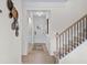 Bright foyer with stairs, wainscoting and neutral decor. and access to multiple rooms at 523 Lanier Way, Temple, GA 30179