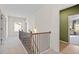 Carpeted upstairs hallway with wood and iron railing, providing access to bedrooms and other living spaces at 523 Lanier Way, Temple, GA 30179