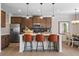 Modern kitchen featuring stainless steel appliances, a kitchen island with stool seating and dark backsplash at 523 Lanier Way, Temple, GA 30179