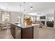 Bright, open kitchen with stainless steel appliances, island, and seamless flow into the adjacent living area at 523 Lanier Way, Temple, GA 30179