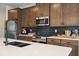 Gourmet kitchen featuring modern appliances, black backsplash, and a quartz countertop at 523 Lanier Way, Temple, GA 30179