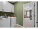 Well-equipped laundry room with modern washer, dryer, and built-in cabinets, conveniently located near the bedroom at 523 Lanier Way, Temple, GA 30179