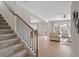 Open living room with light wood floors, a staircase, and a view into the dining room at 523 Lanier Way, Temple, GA 30179