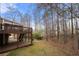A tiered deck offers outdoor living space overlooking the wooded backyard with mature trees and green lawn at 925 Sentry Ridge Xing, Suwanee, GA 30024