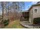 The covered patio and screened-in porch offer serene views of the tree-lined backyard with a stone patio at 925 Sentry Ridge Xing, Suwanee, GA 30024