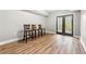 Three high back stools line the space in front of black framed french doors in the basement at 925 Sentry Ridge Xing, Suwanee, GA 30024