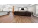 Large basement with wood flooring offers a dark sofa, natural light, and a partially exposed brick column at 925 Sentry Ridge Xing, Suwanee, GA 30024