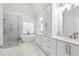 Luxurious bathroom featuring double vanities, a soaking tub, a glass enclosed shower, and elegant finishes at 925 Sentry Ridge Xing, Suwanee, GA 30024
