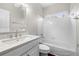Bright bathroom features a single sink vanity with a stylish light fixture and a shower-tub combination at 925 Sentry Ridge Xing, Suwanee, GA 30024