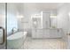Spa-like bathroom featuring double vanities, a soaking tub, a glass enclosed shower, and luxurious finishes at 925 Sentry Ridge Xing, Suwanee, GA 30024
