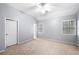 This bedroom features two bright windows with a ceiling fan and a neutral colored carpet at 925 Sentry Ridge Xing, Suwanee, GA 30024
