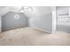 Bright and airy bedroom with vaulted ceiling and a charming round window at 925 Sentry Ridge Xing, Suwanee, GA 30024
