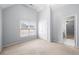 Well-lit bedroom with neutral carpet, features a large window, vaulted ceiling, and closet with double doors at 925 Sentry Ridge Xing, Suwanee, GA 30024