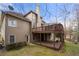 Exterior shot showcases a large back deck with stairs leading to the yard of this two-story home at 925 Sentry Ridge Xing, Suwanee, GA 30024