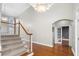 Bright foyer with staircase, hardwood floors, and an arched entrance to another room at 925 Sentry Ridge Xing, Suwanee, GA 30024