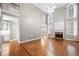 Bright living room featuring hardwood floors, a fireplace, and tall windows at 925 Sentry Ridge Xing, Suwanee, GA 30024