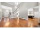 Spacious living room showcasing hardwood floors and views of kitchen and entry way at 925 Sentry Ridge Xing, Suwanee, GA 30024