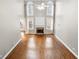 Spacious living room featuring a fireplace, hardwood floors, and large windows offering plenty of natural light at 925 Sentry Ridge Xing, Suwanee, GA 30024