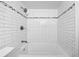 Modern tub/shower combo with white subway tile and decorative tile accents adds value at 10 Chaumont Nw Sq, Atlanta, GA 30327