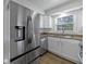 Updated kitchen with stainless steel appliances and white cabinetry at 10 Chaumont Nw Sq, Atlanta, GA 30327