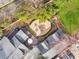 Aerial view showcasing an outdoor deck, a stone patio with a fire pit, and lush, mature landscaping at 1466 University Dr, Atlanta, GA 30306