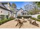 Inviting backyard features a stone patio with a fire pit and chairs, perfect for relaxing and entertaining guests at 1466 University Dr, Atlanta, GA 30306